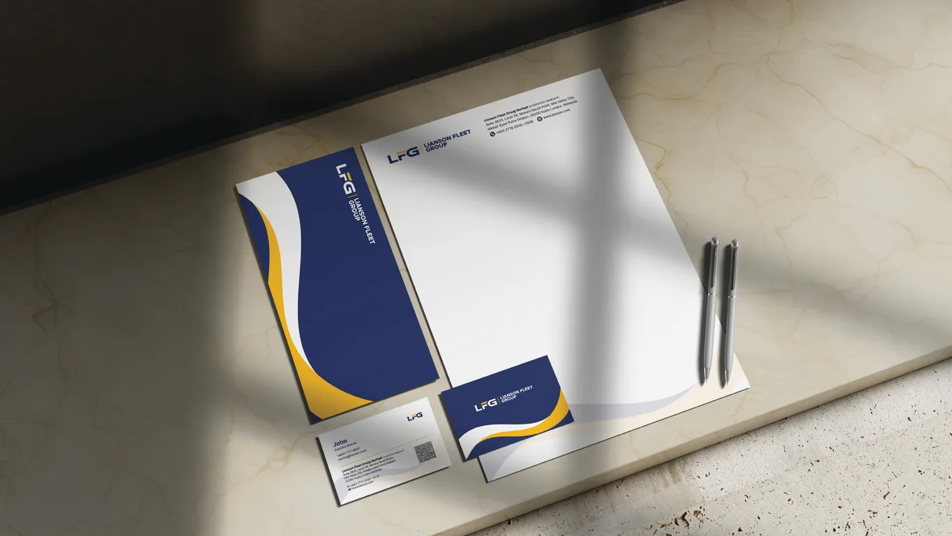 Lianson Fleet Group stationery flat lay with letterhead, business cards and pens on a marble surface