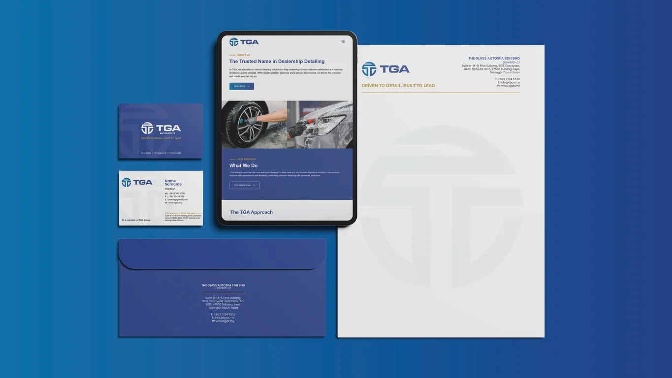 TGA stationery suite of business cards, envelope and letterhead beside a tablet showing the corporate website