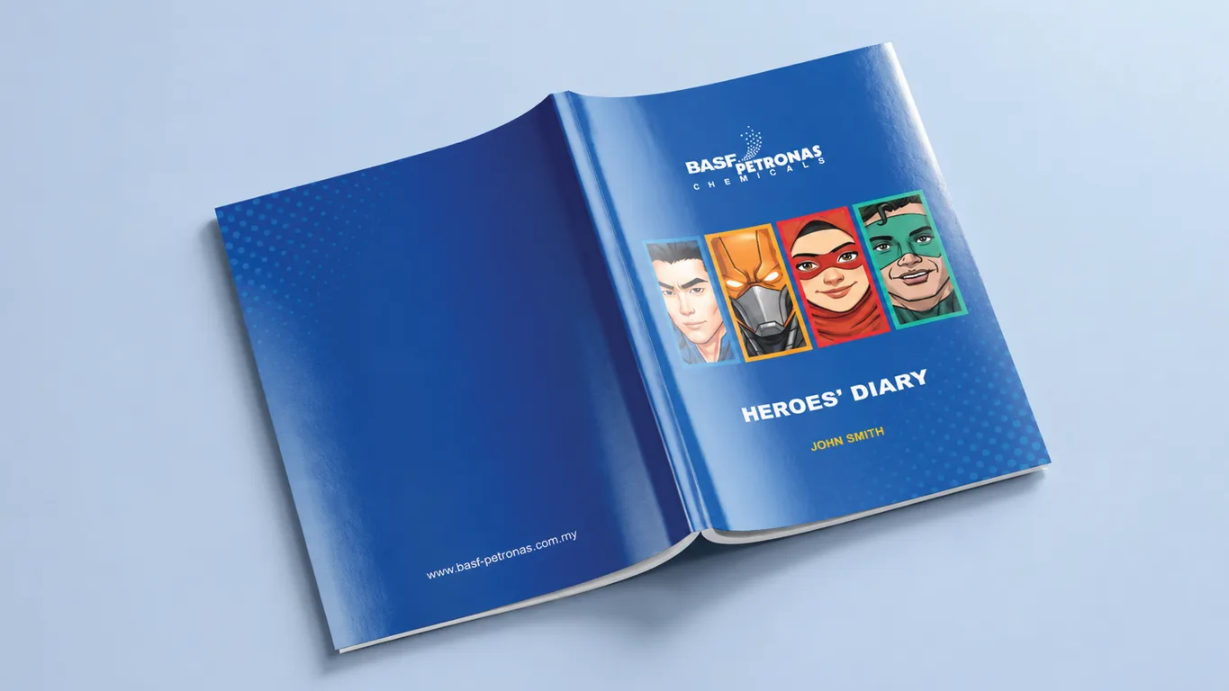 BASF Malaysia Heroes' Diary opened flat, blue cover carrying four superhero portraits and a personalized name